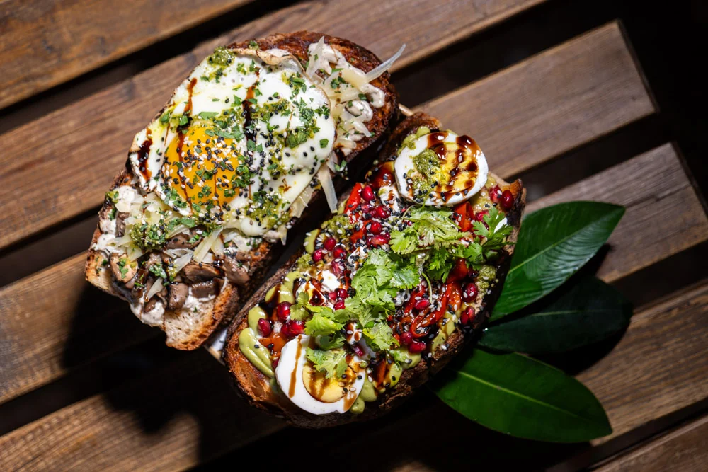 Open gourmet ftira bakes on a wooden bench