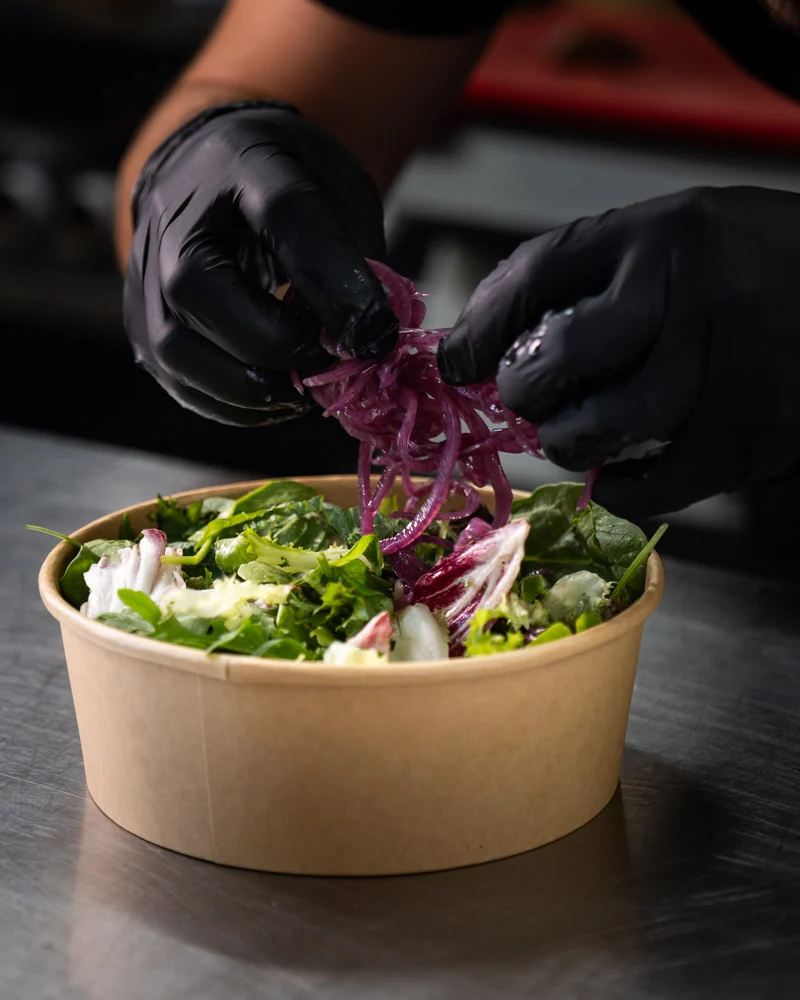 A Streatery bowl being finished by hand in the kitchen
